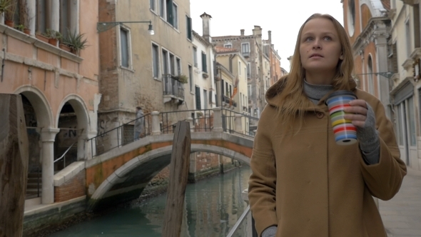 Woman Having Coffee While Walking In Venice alt