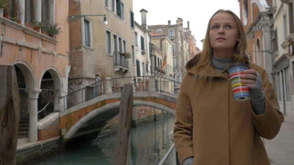 Woman Having Coffee While Walking In Venice