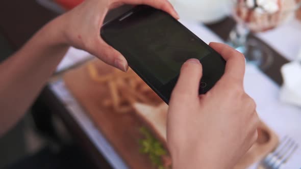 Woman Taking Pictures of Food By Phone