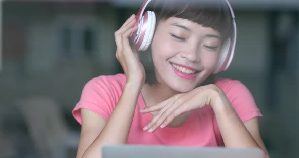 Cheerful woman listen to music at home