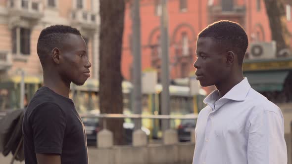 young smiling African men greeting in the street. Friendship, ethnicity