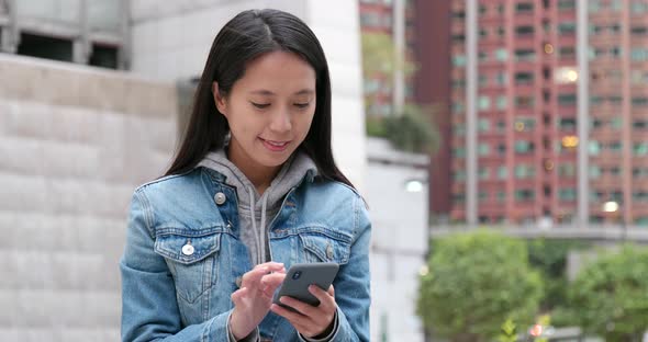 Young woman work on cellphone at outdoor