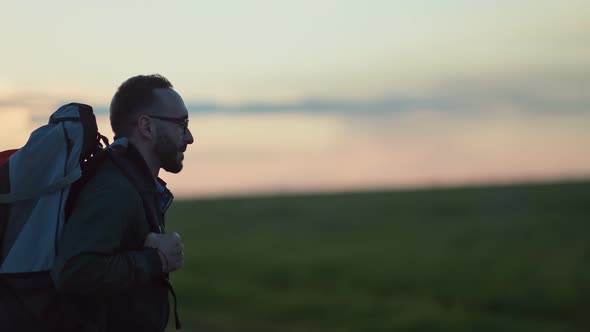 Backpacker Guy Enjoying Hiking Tourism Walking on Natural Landscape at Sunset