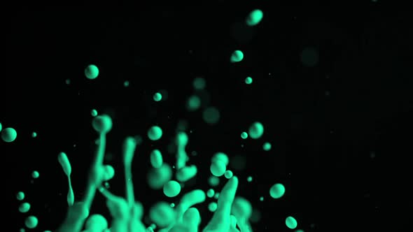 Green Droplets Of Paint Flying Up Into Air