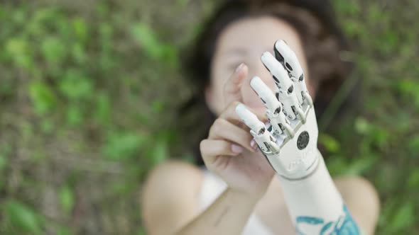 Girl is walking and resting in park Bionics Cybernetic Robotic-arm Hand prosthesis