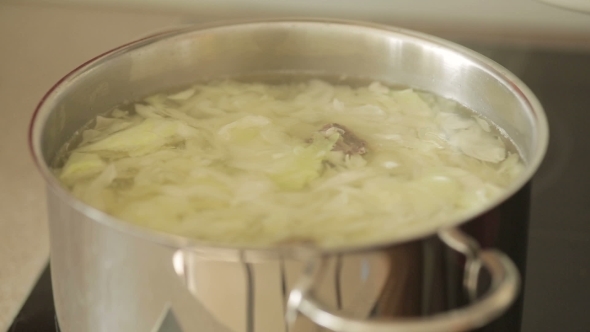 Cooking Pots And Stirring The Mixture