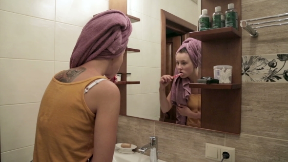 Young Woman Brushing Teeth