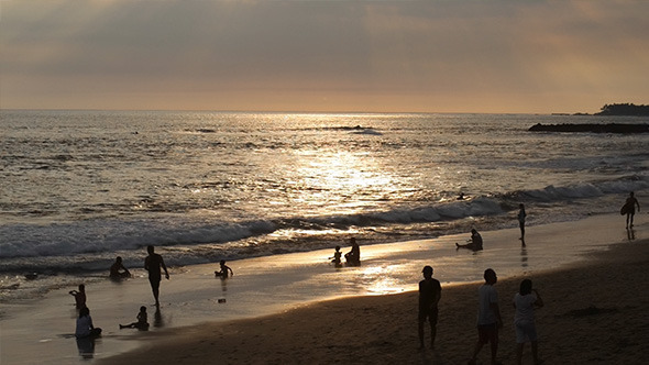 Tropical Beach with People in Sunset