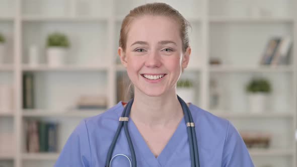 Smiling Young Female Doctor Talking on Video Call