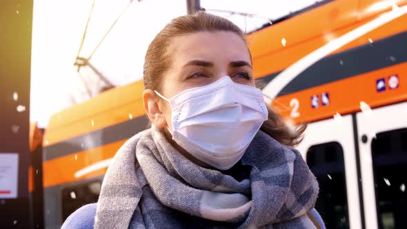 Woman in Face Mask at Railway Station in Winter