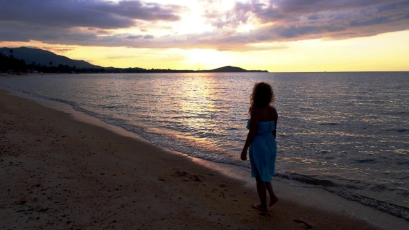 Beautiful Young Woman Walking At The Sea Against alt