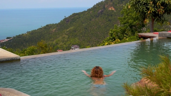 Woman Swimming In Endless Swimming Pool