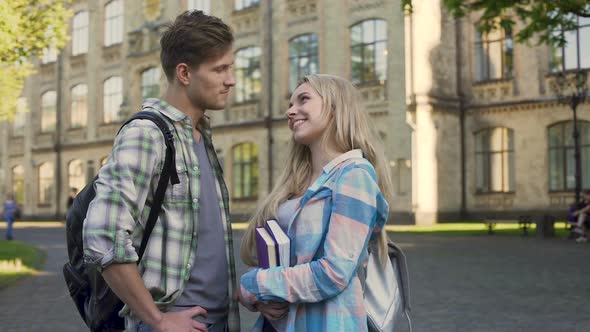 Couple Standing Near Academy and Looking at Each Other, Love and Relationship