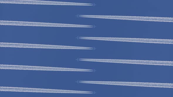 Airplanes Fly Towards Each Other and Leaving Horizontal Traces on a Clear Blue Sky