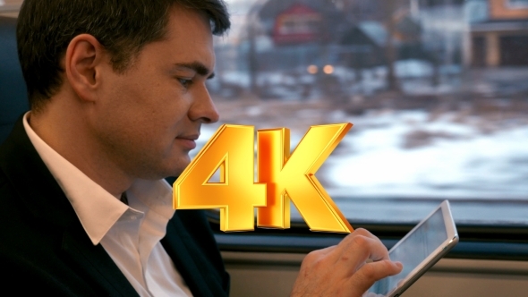 Businessman Traveling By Train With Tablet PC