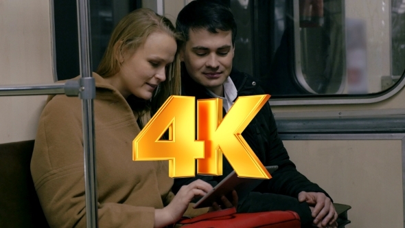 Couple With Tablet PC In Public Transport