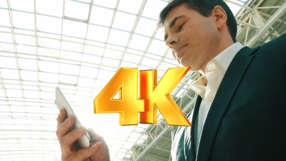 Businessman With Smartphone In Modern Building alt