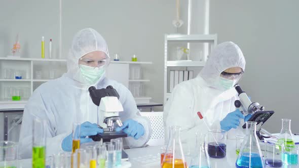 A western scientists couple working on test tube to analysis and develop vaccine of covid-19
