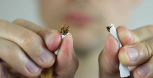 Man Breaking a Cigarette