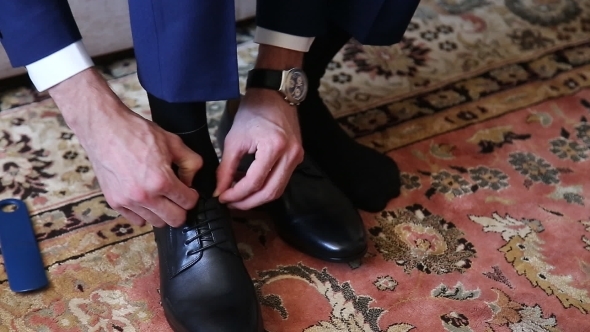 Man Puts On Shoes