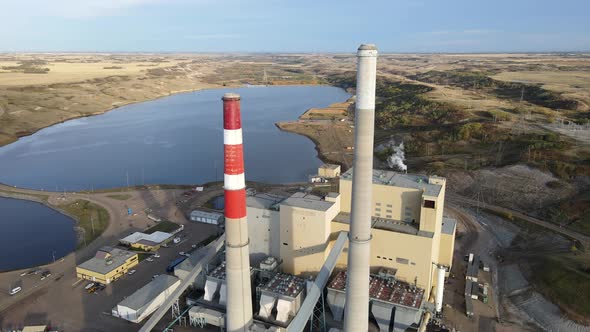 Aerial 4k footage of generating plant in north american countryside during sunset. Slow forward flig