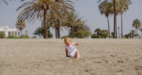 Young Beautiful Girl Playing In Sand