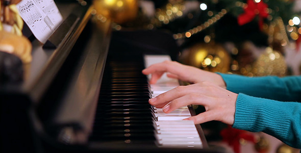 Girl Playing Piano near Christmas Tree 3