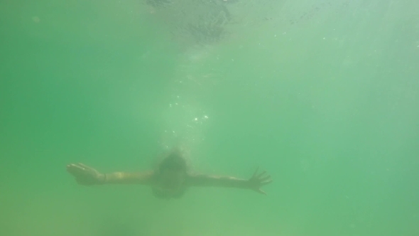 Woman Swimming Underwater In The Sea