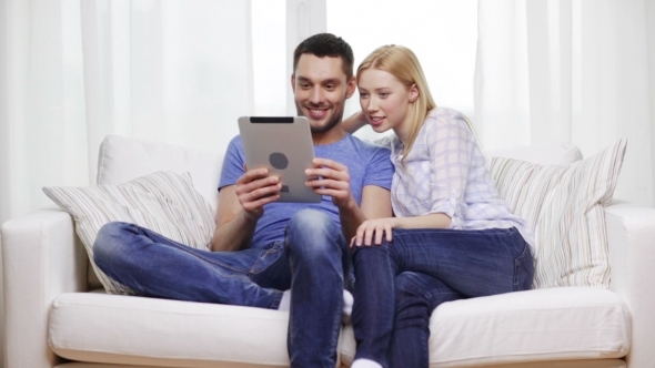 Happy Couple With Tablet Pc At Home