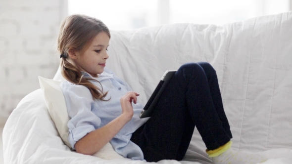 Little Girl With Tablet Pc At Home