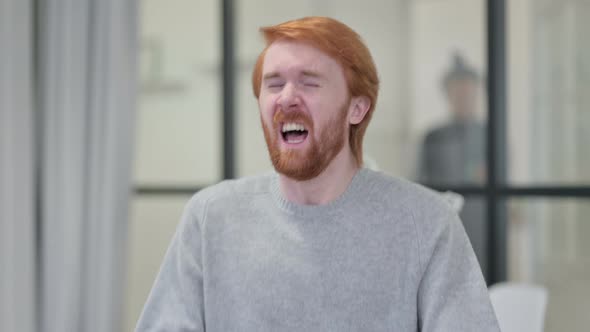 Portrait of Sick Young Redhead Man Sneezing 