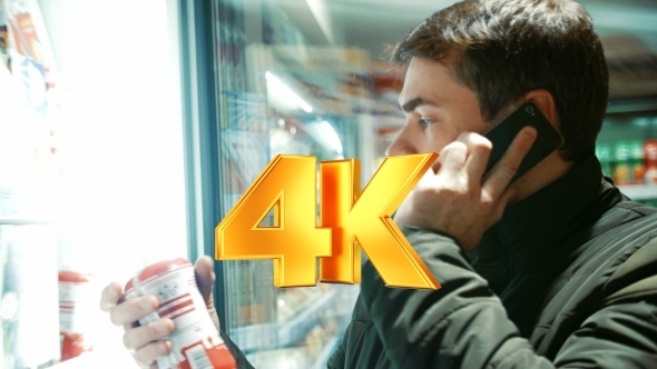 Man Talking On The Phone In Food Store alt