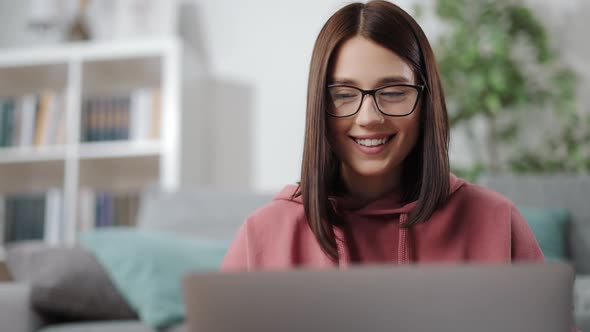 Smiling Woman Working From Home on Laptop