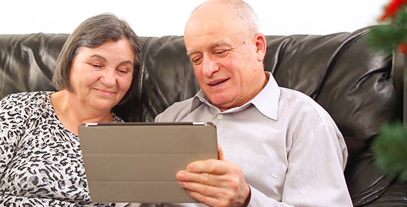 Senior Couple Using Digital Tablet at Christmas 3