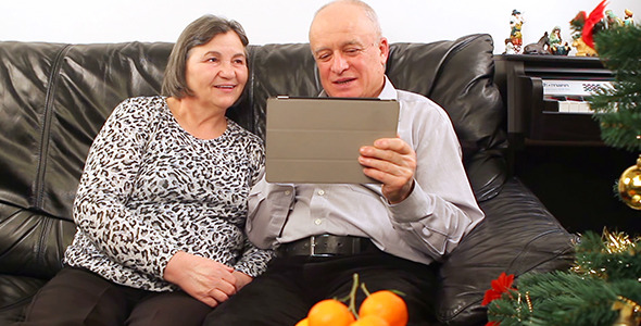 Seniors Couple Using Tablet Pc with Video Chat