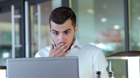 Young Man Having Some Problems With His Laptop alt