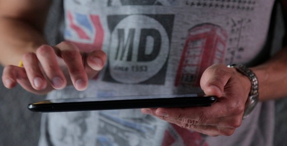 Man Typing On The Tablet