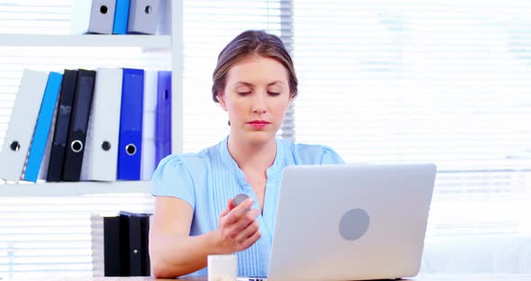 Female doctor working over laptop at her desk