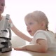 Child Baby Caucasian Little Boy Scientist Biologist Researcher Working with Microscope and Show It - VideoHive Item for Sale