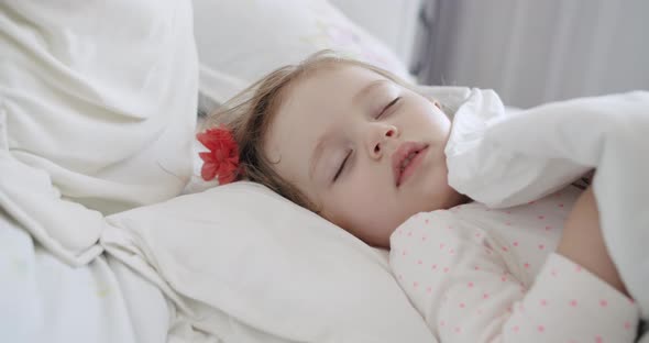 Adorable Oneyearold Girl Sleeping Peacefully in the White Bedroom