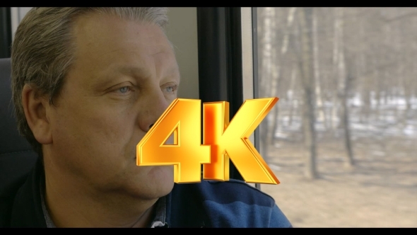 Man Enjoying Outside Scenery From Train Window alt