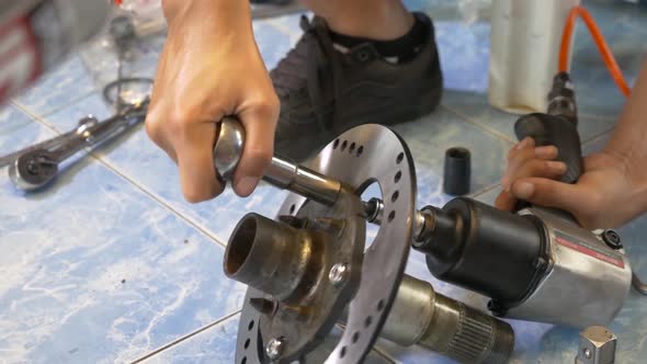 Close-up Footage of The Technician Working On Motorcycle Brake Caliper Cleaning Process