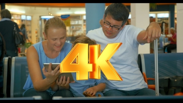 Family Waiting For Departure With Tablet PC alt