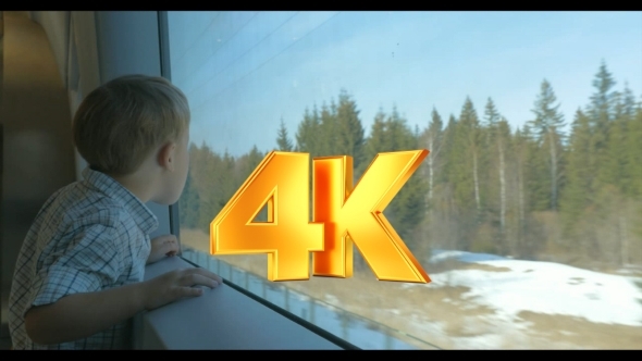 Boy Looking At Nature Scene Through The Train