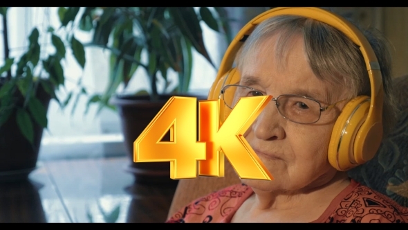 Senior Woman Listening To The Music In Headphones