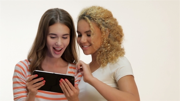 Two Woman Holding Tablet Computer