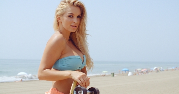 Seductive Woman With Skateboard At The Beach