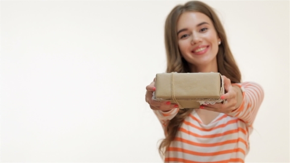 Young Woman Holding a Present In Hands