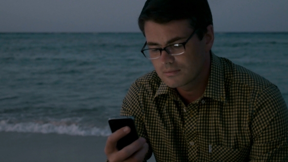 Man Using Smartphone By The Sea alt