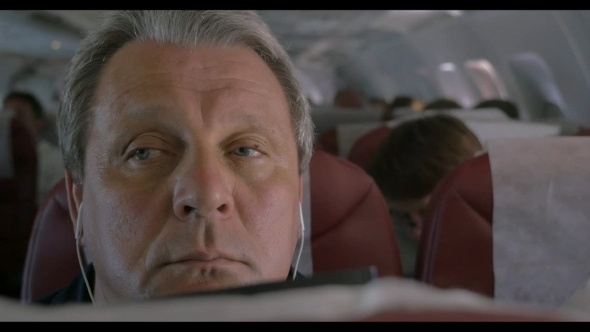 Sleepy Man Listening To Music In Airplane alt